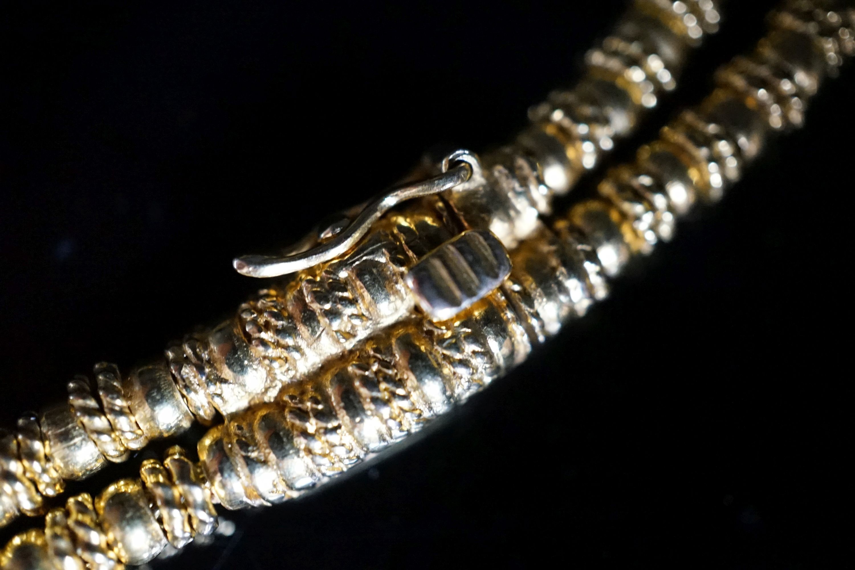 Ilias Lalaounis: a 750 yellow metal multi strand necklace, with shell motifs, 40cm, 146.3 grams, signed.